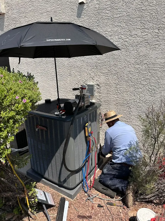 HVAC technician performing outdoor AC maintenance in James Island