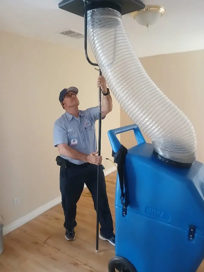 Furnace Tune-Up technician using HEPA equipment in James Island